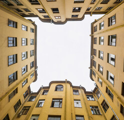 narrow and deep courtyard-well formed by closely standing walls of houses