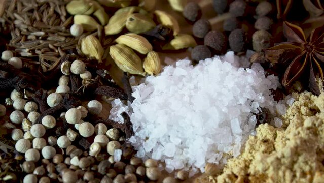 Close-up. Various spices and coarse salt for marinating. Black pepper, cumin, coriander, turmeric, salt.