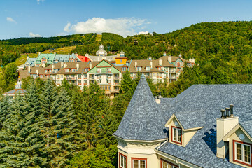 Fototapeta na wymiar Mont Tremblant, beautiful national park and village in harmony with nature, Tiled roofs of hotels. The unique and wonderful resort village of Mont Tremblant, Quebec, Canada. High quality photo
