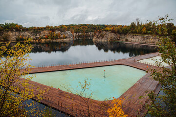 Fototapeta na wymiar Popular touristic spot Zakrzówek Quarry, Krakow. Floating swimming pool. Cloudy autumn day