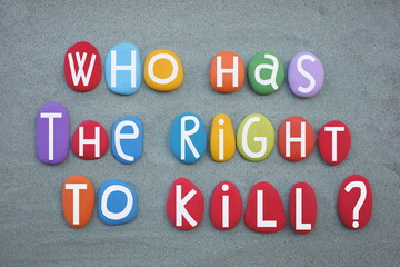 Who had the right to kill, moral question composed with multi colored stone letters over green sand