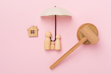 Wooden family figures with judge's gavel on color background,top view