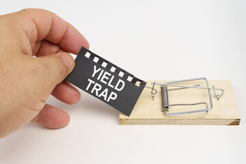 A man pulls the bait from a mousetrap. Bait, a sheet of black paper with the inscription - yield trap