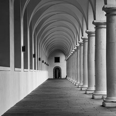 The beautiful architectural structure of the arcade with Gothic columns in the stable yard of the Dresden Residence Palace. Very contrasting light and shadow play.
