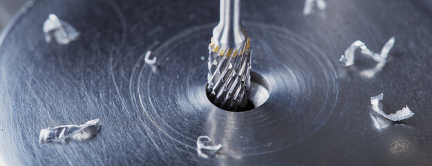 Milling cutter make sink in hole in steel billet. Locksmith work.