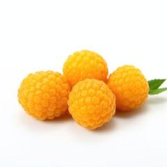 A group of yellow raspberries sitting on top of a white surface.