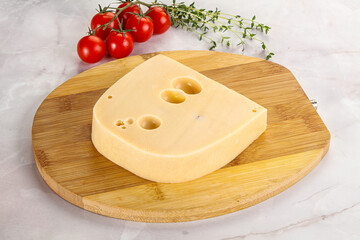 Maasdam cheese brick over board