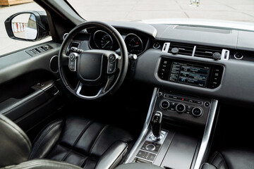 Front of the car, driver's seat, steering wheel, automatic transmission.