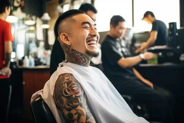 Foto op Aluminium Asian man sitting at a barbershop getting haircut smiling © blvdone