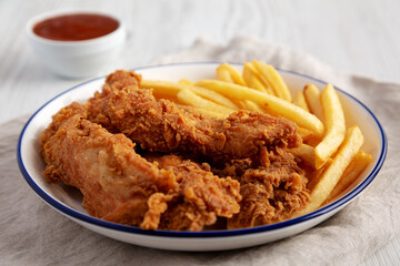 Crispy Chicken Strips with French Fries and Sour-Sweet Sauce