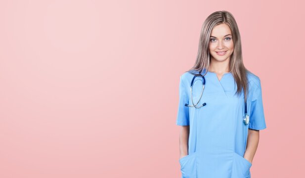 Image of young doctor smiling on color background.