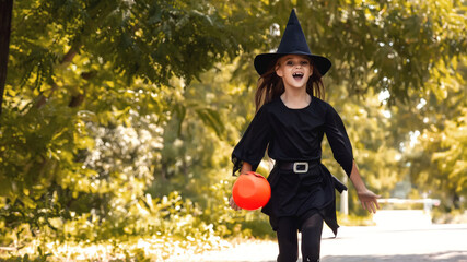 little girl with long dark hair smiles in a Halloween witch costume outside. Halloween for children