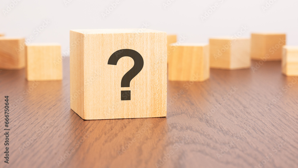 Poster wooden cube block shape with sign question mark symbol on brown background