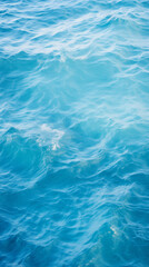 Fototapeta premium Tranquil ocean surface, showcasing gentle ripples that dance across the serene blue canvas. The subtle interplay of light and movement evokes a sense of peace, making it ideal for relaxation content.