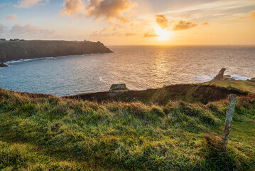 Beautiful dramatic Summer dawn over Lizard Point in Cornwall UK with lovely glowing sky and clouds