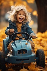 a little girl is playing with leaves while riding on the car