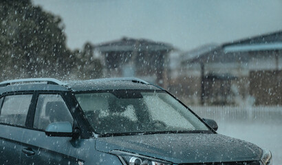 Heavy rain with hail at summer on car parking