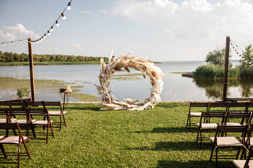 round arch made of pompass grass. outdoor ceremony in summer