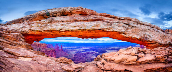 Mesa Arch with an incoming storm,.view to canyon and washerwoman Arch,Island in the Sky...