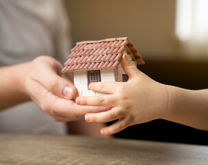 A father gives his son a small house. The concept of transfer of property and inheritance. Real...