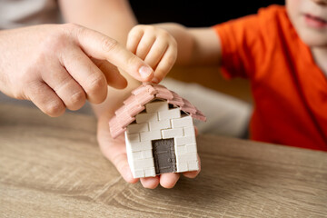 A father gives his son a small house. The concept of transfer of property and inheritance. Real...
