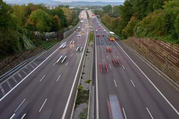 Long exposure photo of traffic with blurred traces from cars, top view. road, cars, blurred traffic, evening, top view. Highway at evening, blue hour illuminated by the traffic of cars