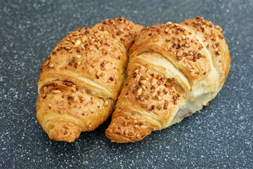 Fresh warm croissants on a plate.