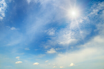 Naklejka na ściany i meble Blue sky , sun and beautiful white clouds.