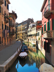 A Colorful Back Canal in Venice Italy with Reflected Boats Giving it an Abstract Appearance - 666774483