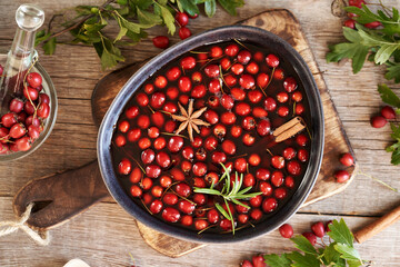 Preparation of medicinal wine from wild hawthorn berries in a bowl