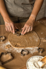 Step 4 in making homemade cookies or gingerbread. Holiday concept. Home baking concept.
Step by step process for making homemade cookies.Female hands cutting out cookies from dough with cookie cutters