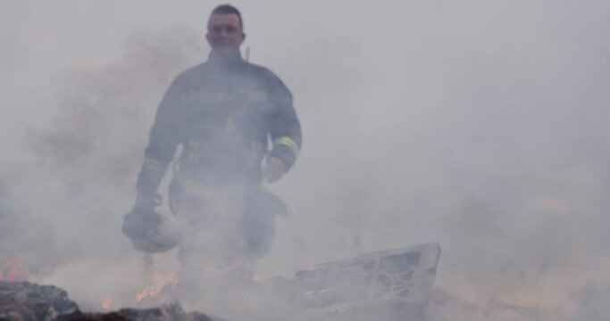 Portrait of a heroic fireman in a protective suit. Firefighter in fire fighting operation.