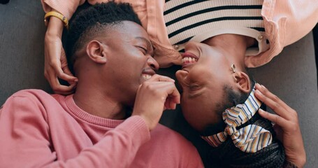 Love, happy and couple on a floor bonding, laugh and care with nose touch intimacy from above. Top view, smile and playful black people share romance, support or communication, trust or relax at home