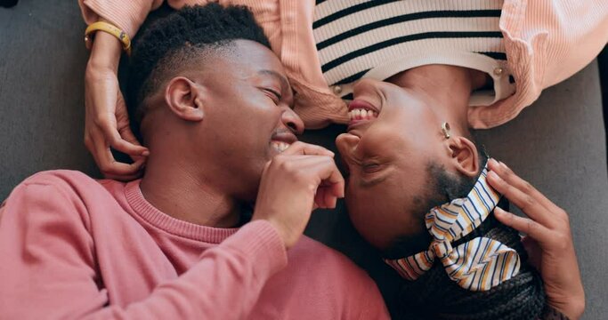 Love, happy and couple on a floor bonding, laugh and care with nose touch intimacy from above. Top view, smile and playful black people share romance, support or communication, trust or relax at home