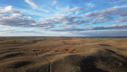 Autumn hills and beautiful sky with clouds. Drone photography of a view of the evening horizon and limitless space. USA Midwest landscape. South Dakota in fall colors.