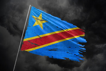 Dr Congo torn flag on dark sky background.