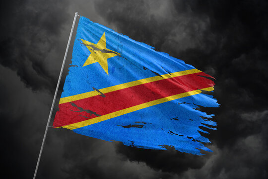 Dr Congo torn flag on dark sky background.
