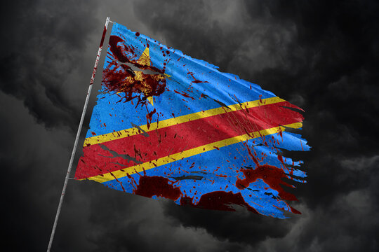 Dr Congo torn flag on dark sky background with blood stains.