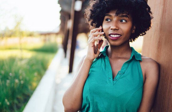 Beautiful African American hipster girl calling via modern cellular gadget