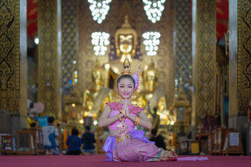 Lantern Festival or Yi Peng Festival in Hundred Thousand Lantern with the pretty Asian girl wearing beautiful Thai traditional dress Lanna style Phra That Hariphunchai temple Lamphun, Thailand.
