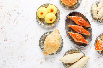 Traditional Azerbaijan holiday Novruz background with green semeni,traditional azerbaijan sweets,shekerbura,qogal,paxlava,mutaki and different nuts and sweets,top view,space for copy