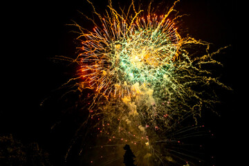 Holiday fireworks explode in the night sky. 4th of July celebration. Selective focus. 