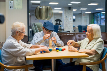 Elderly residents in a nursing home sharing skills games