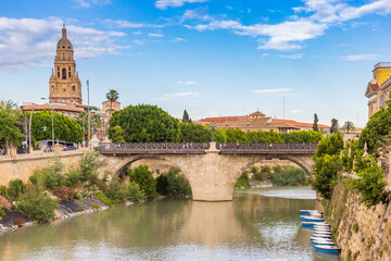 View over the Segura river, cathedral and historic bridge in Murcia, Spain