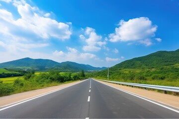 Asphalt road and green mountain under blue sky