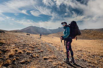 Fototapeta premium Woman on road leading to volcano in Turkey