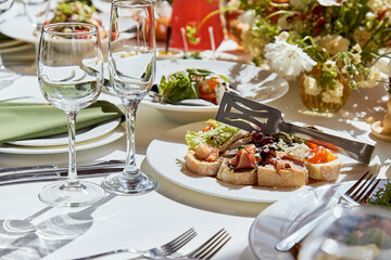 Graceful setup of chambers table, featuring interplay of candles and arranged flowers under shadows. Wedding imbued with the elegance of Provence