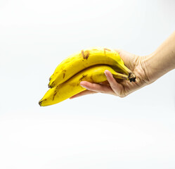 Female's hand with manicure holding bunch of bananas