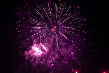 Fireworks explode in the night sky. Selective focus.