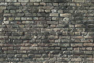 gray wall made of old brick close-up